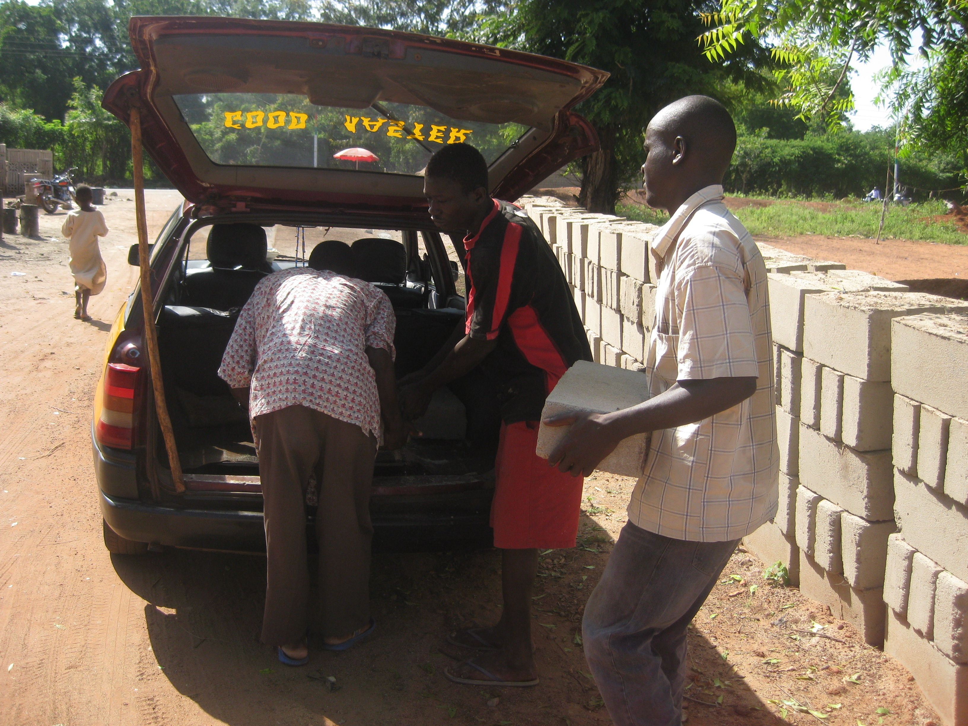 IMG_3670 Loading up the taxi with bricks, cement, and sand to bring to Jarigu