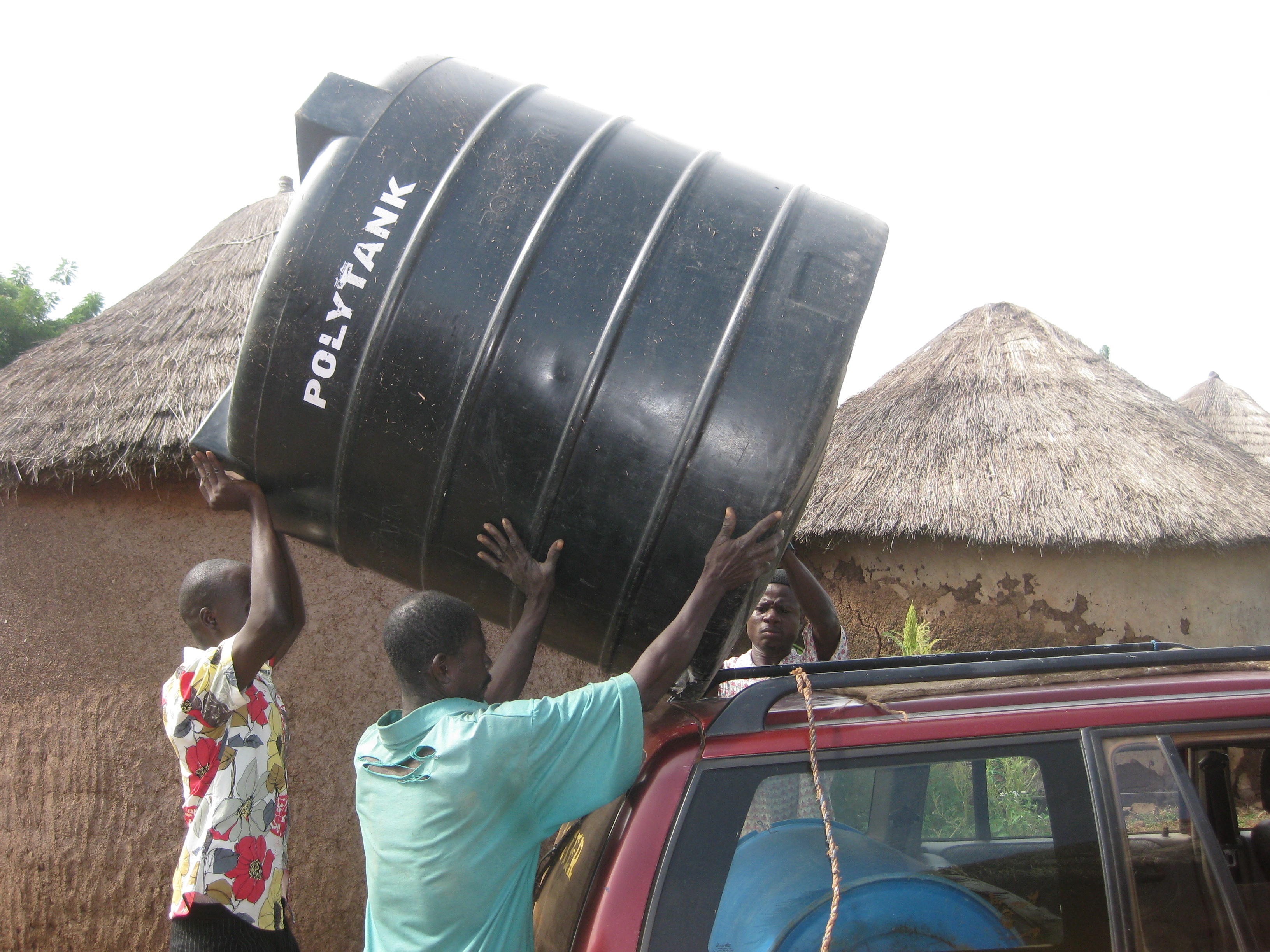 IMG_3728 Loading the polytank onto the roof of the taxi - apparently the Tamale police didn't think that this was a funny as I did!