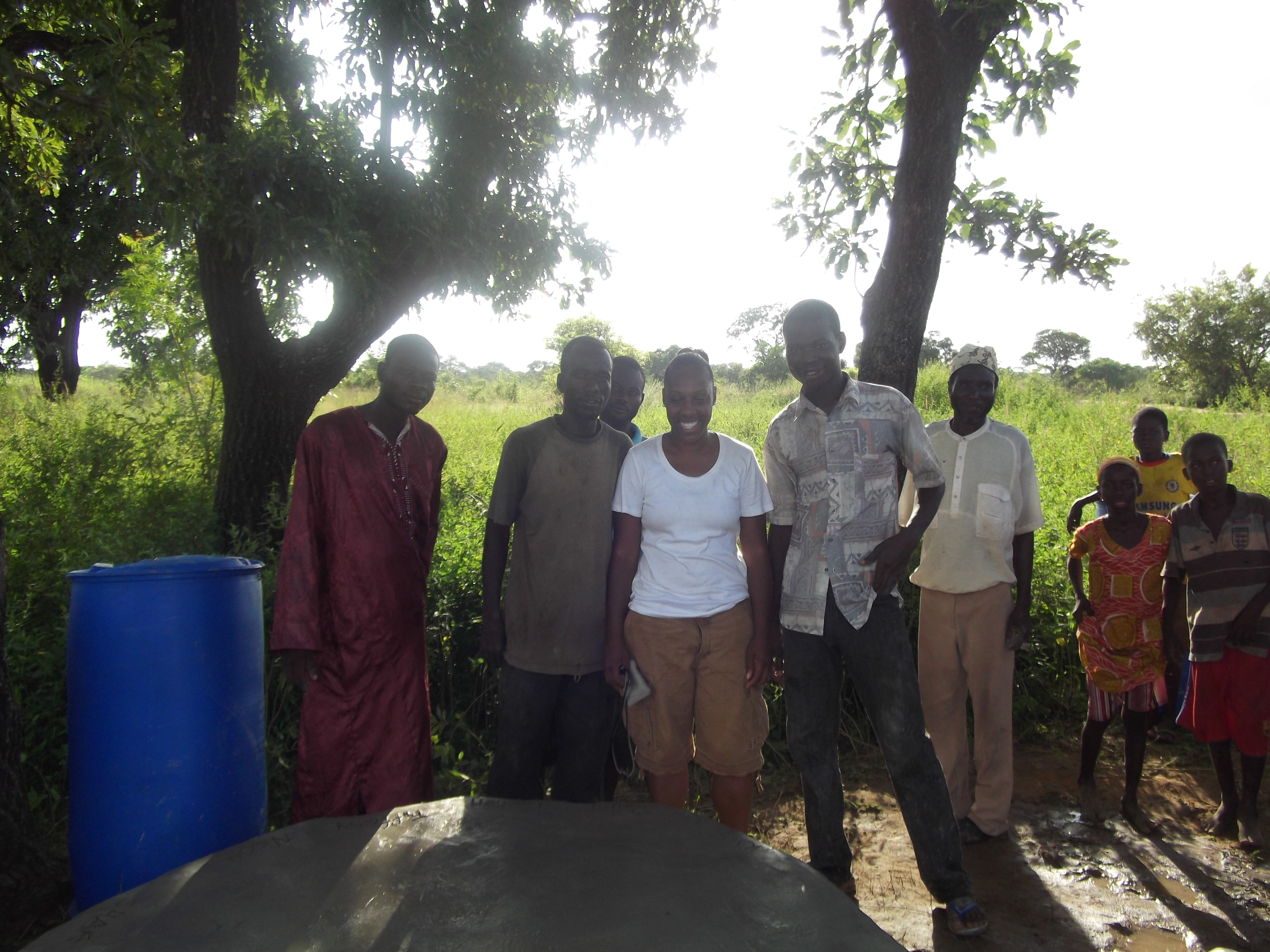 Tiffany and some men of Tijo snap a proud pic in front of thier finishedpolytank stand