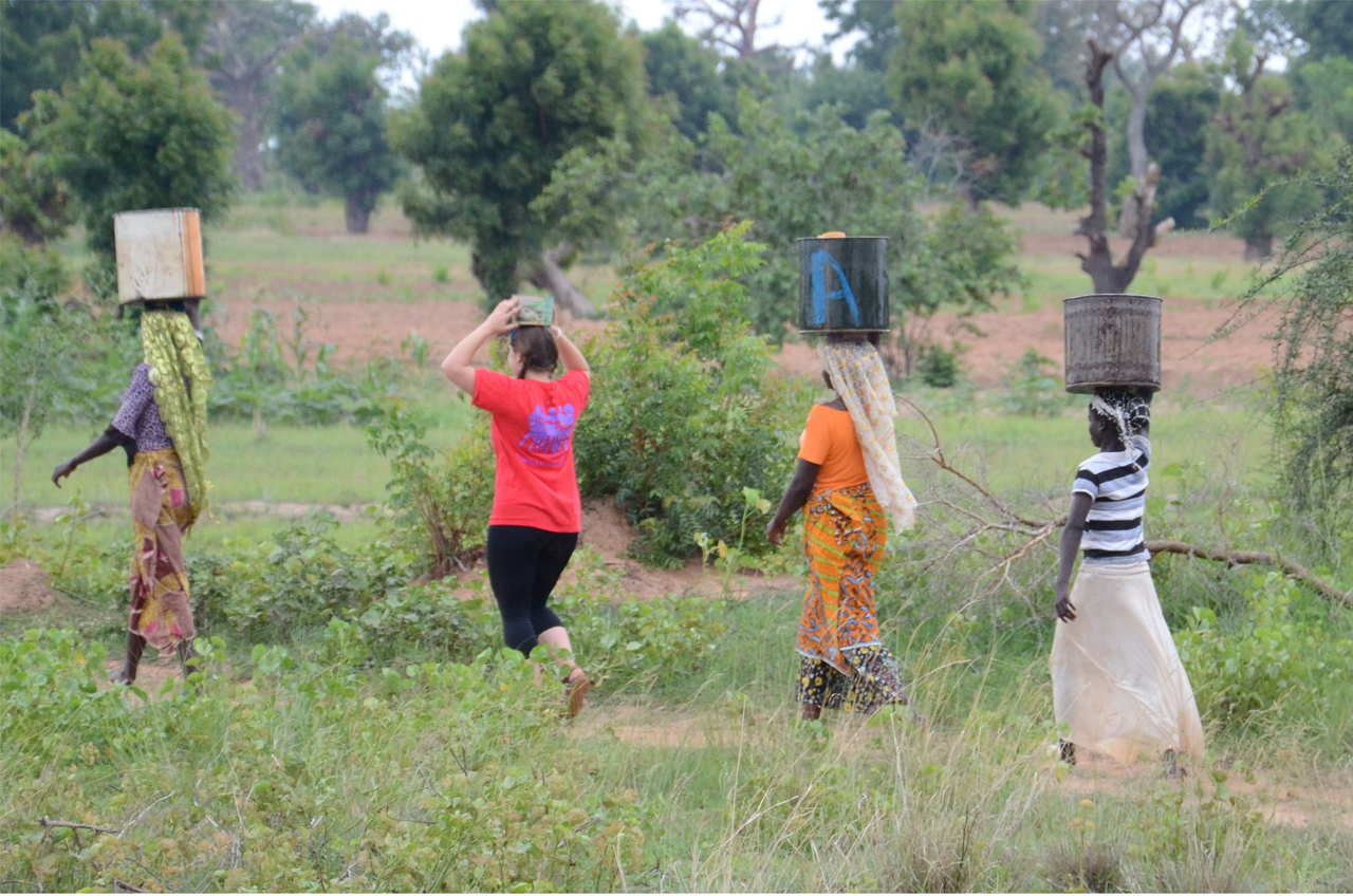 Maxine helping the ladies fetch water!