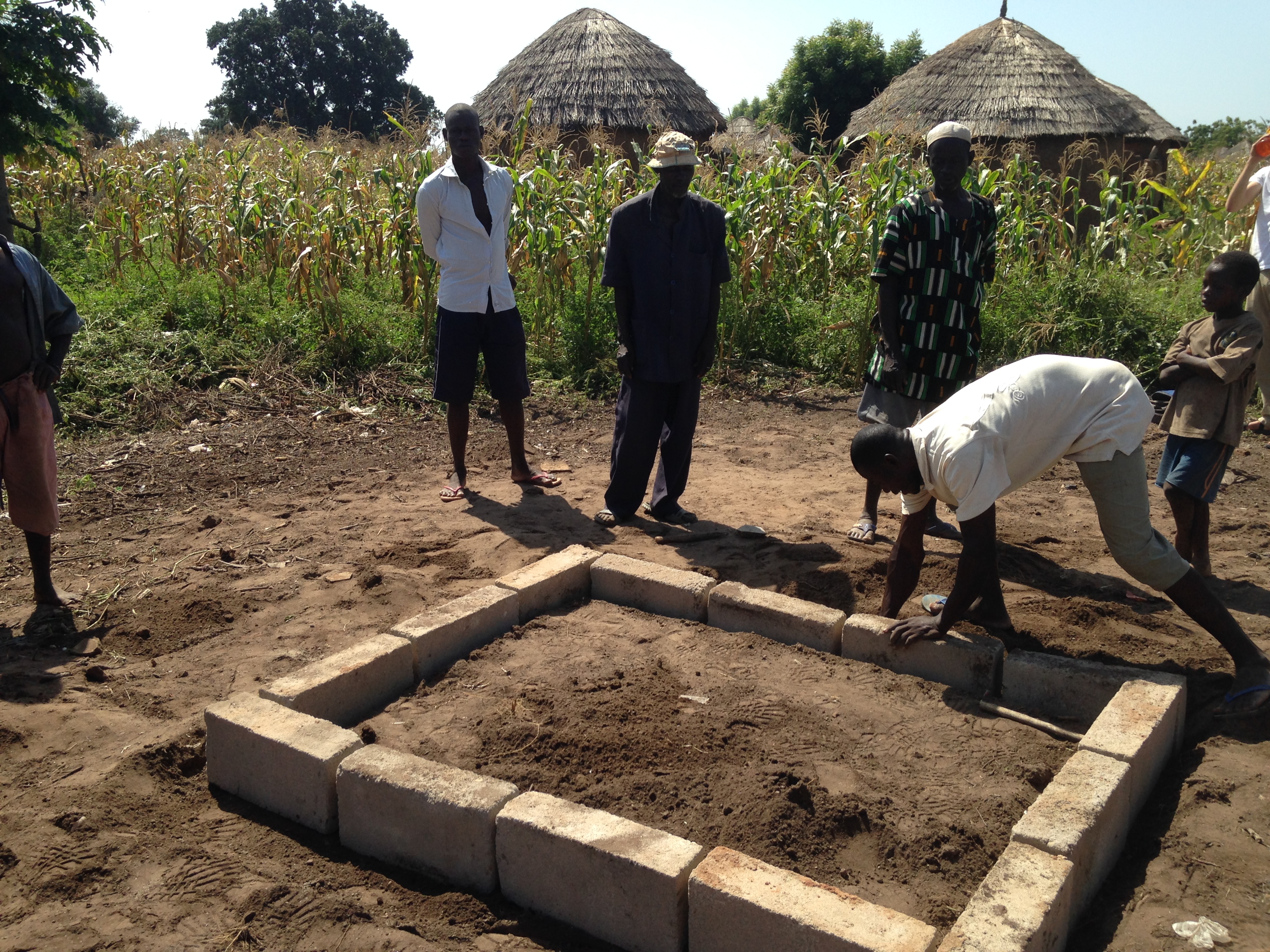 The village mason and his team constructing the foundation.