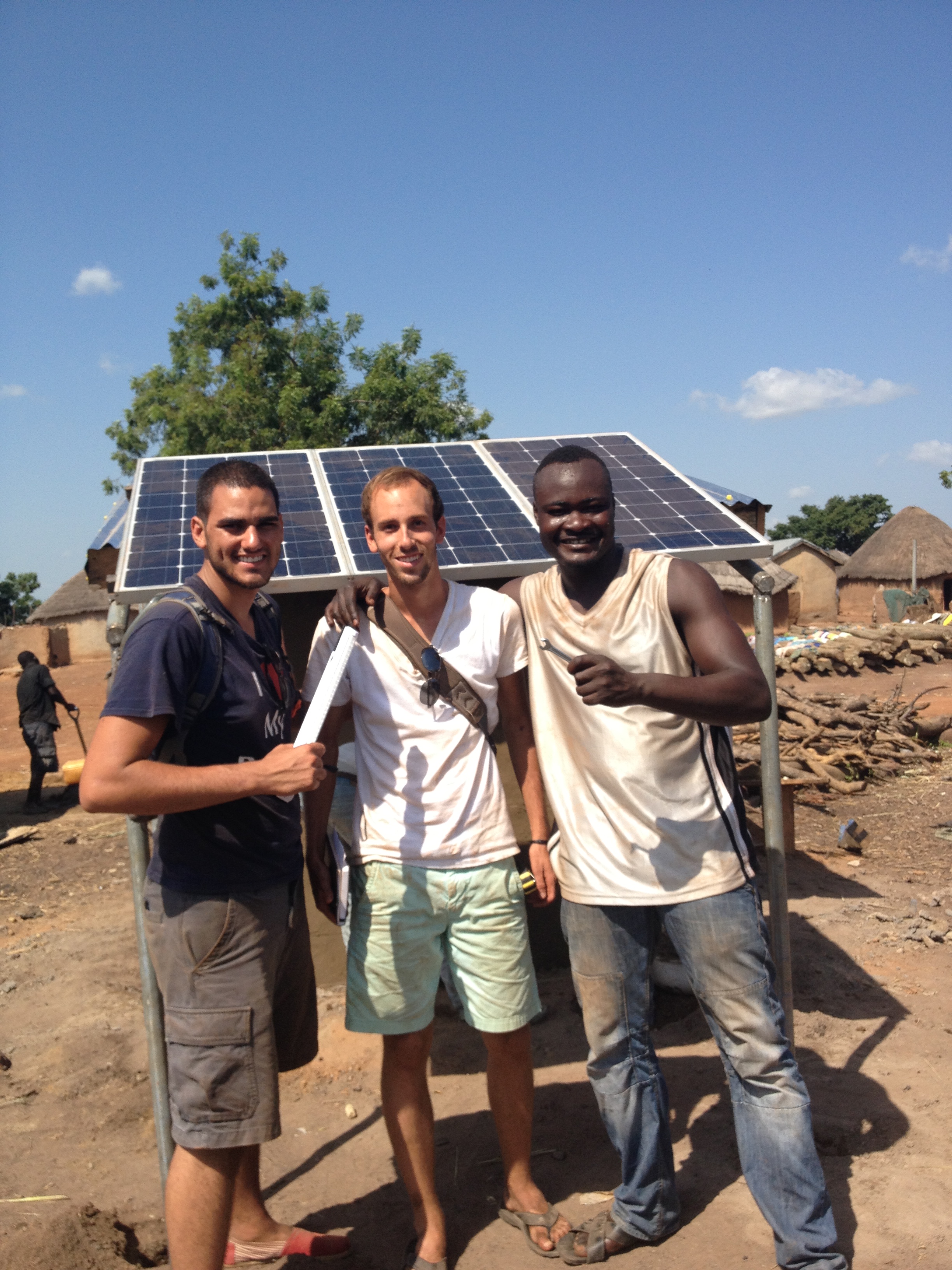 Mark, Ben, and Shak celebrating the completed solar panel installation.