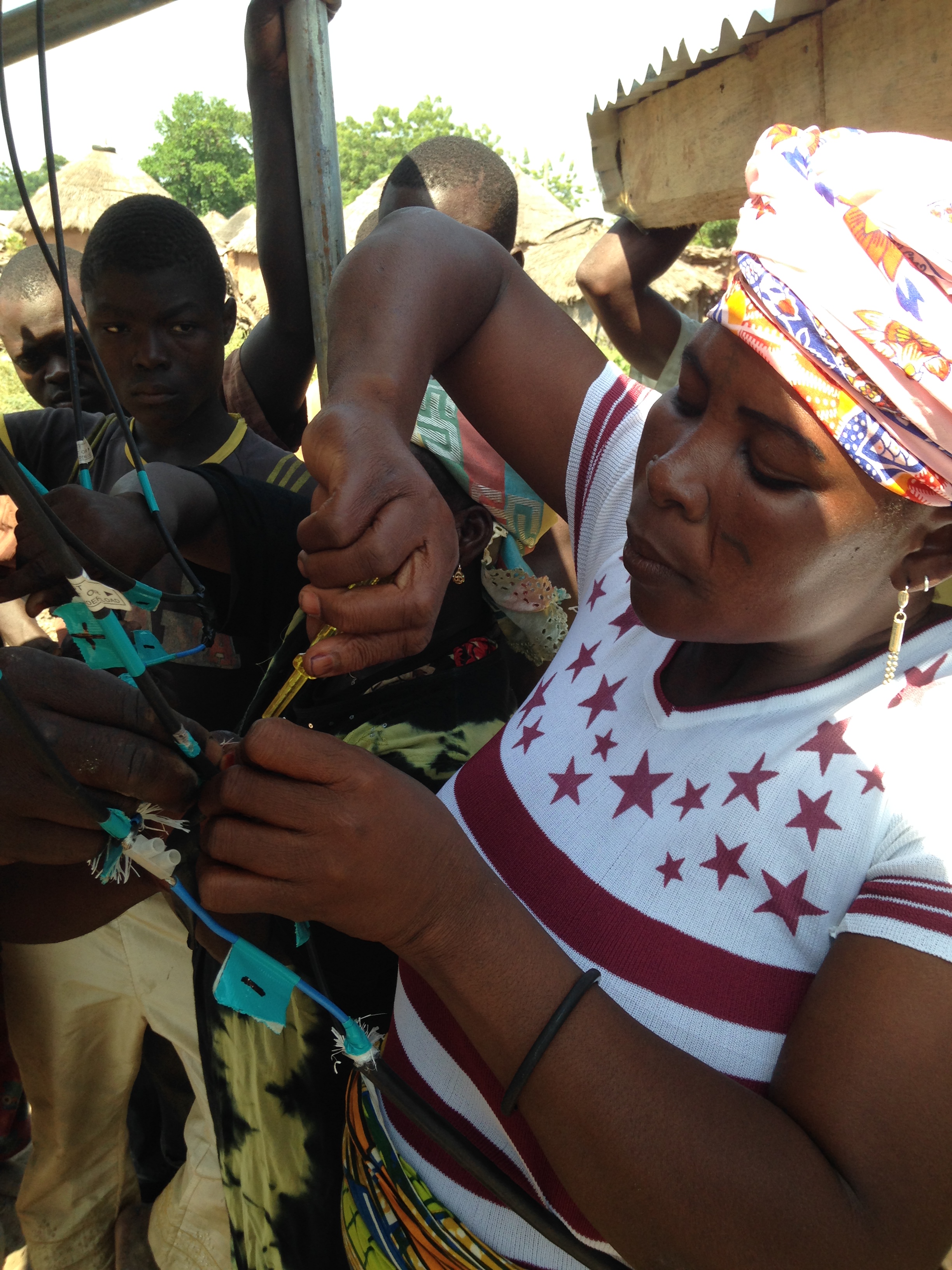 Salima connecting the wiring from the Solar Panels.
