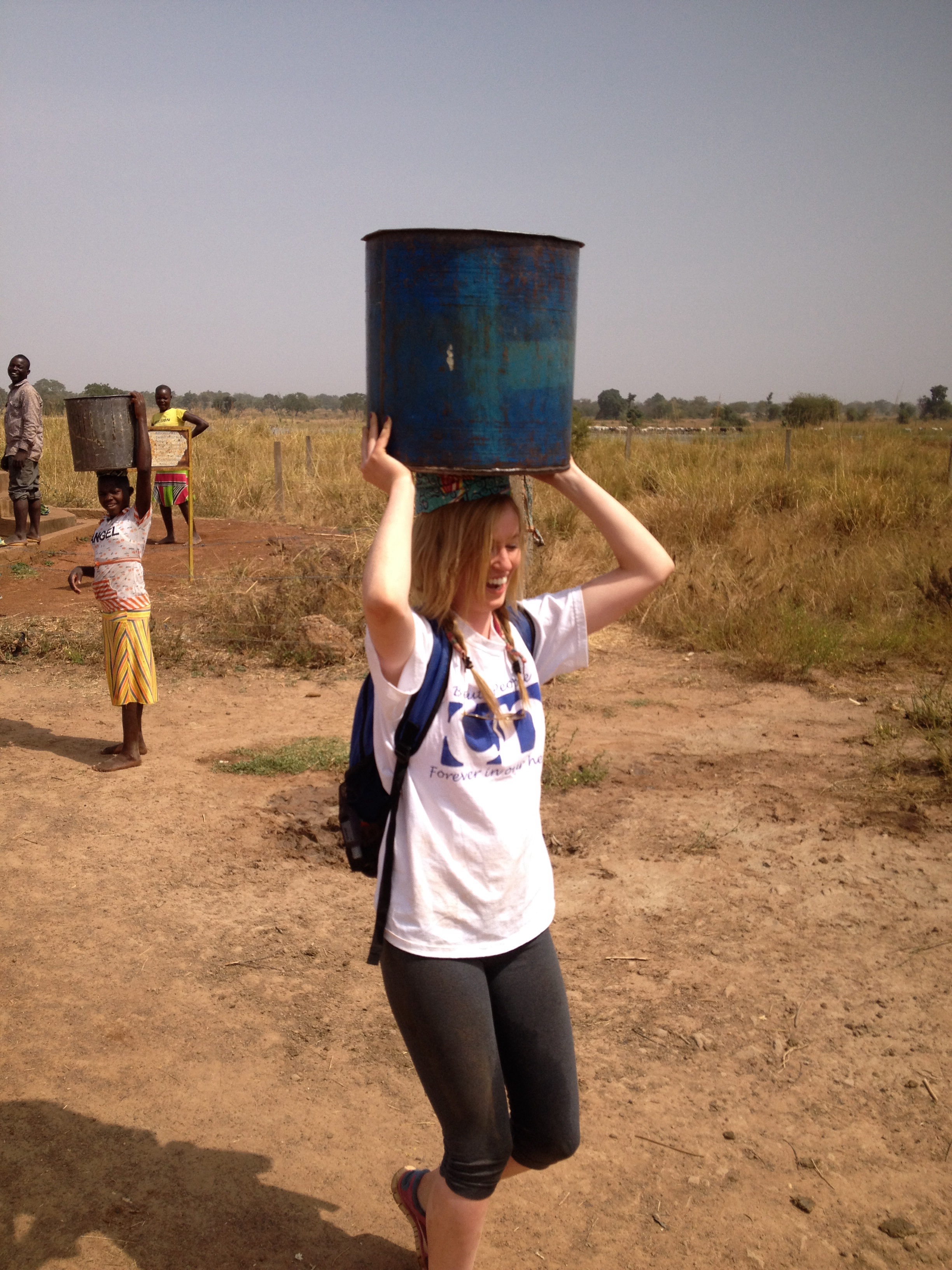 Caroline helps out to collect water